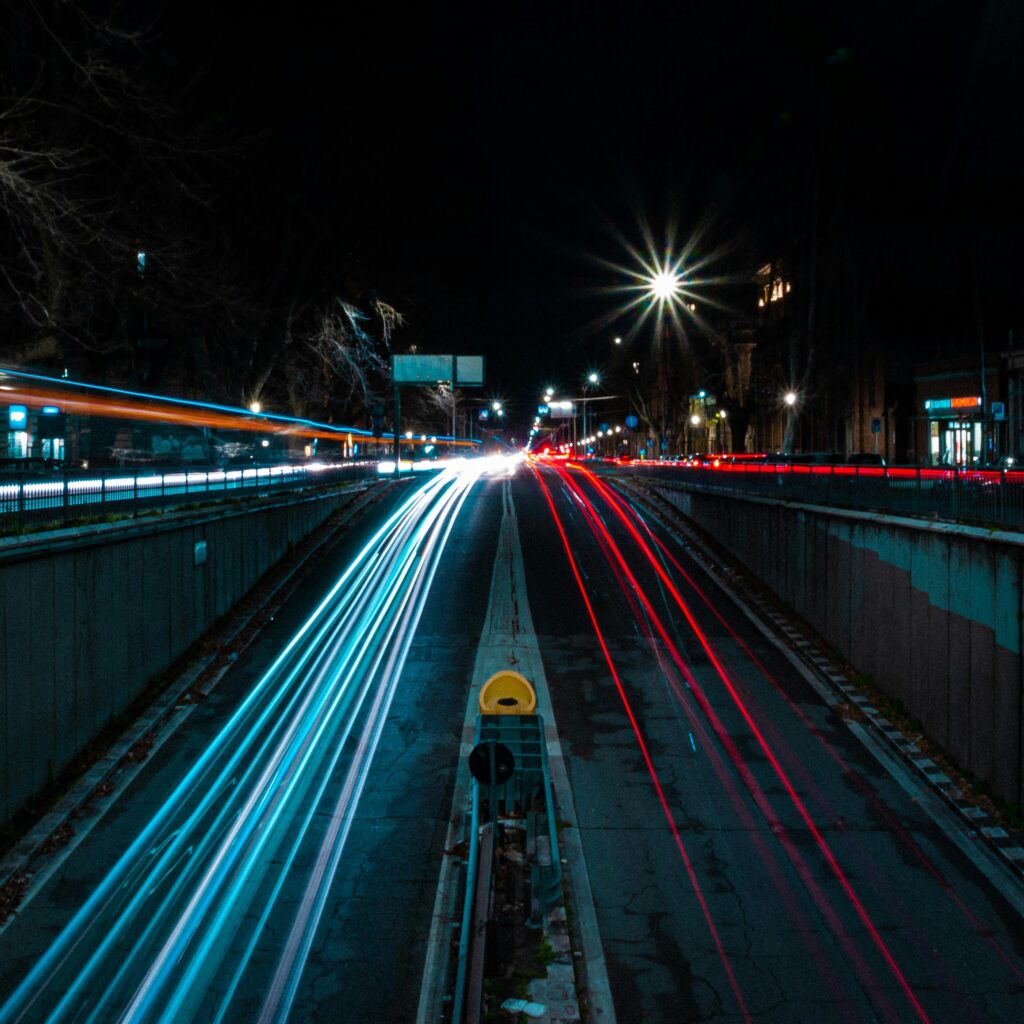 Nighttime city street with vibrant light trails showcasing long exposure photography highlighting build your brand fast